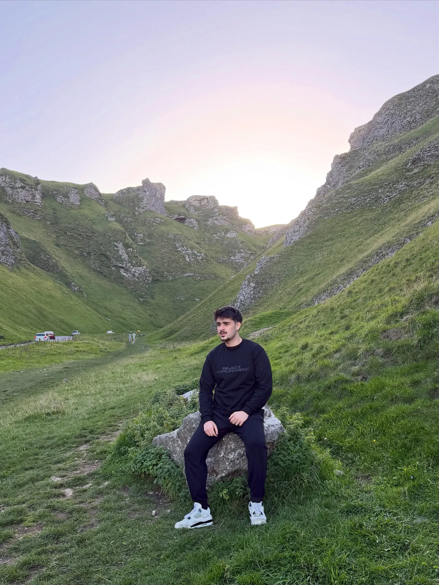 Sitting on a rock in Winnats Pass wearing the tonal longsleeve